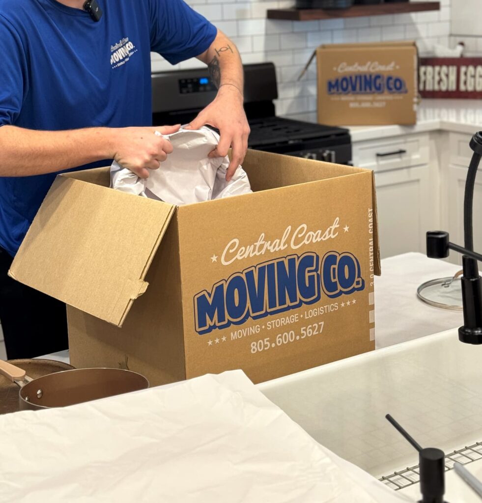 central coast moving employee packing dishes