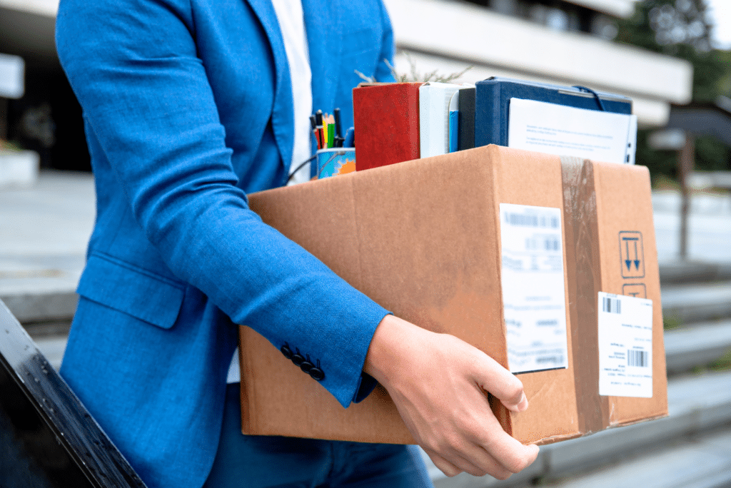 man in suit moving a box