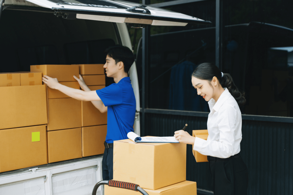 two workers packign materials to move